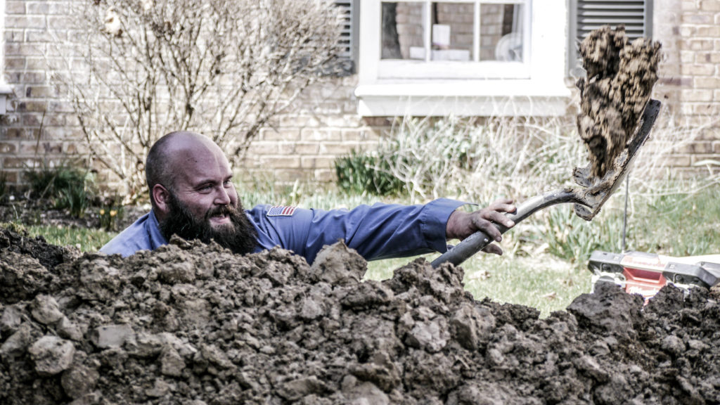 The Scottish Plumber digging to repair sewer