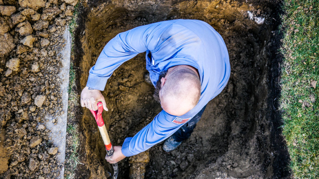 The Scottish Plumber digging up a broken sewer.