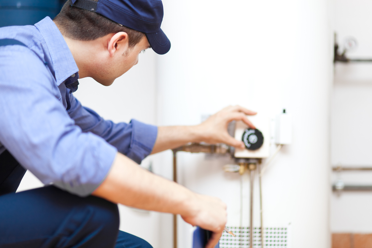 The Scottish Plumber works on a water heater